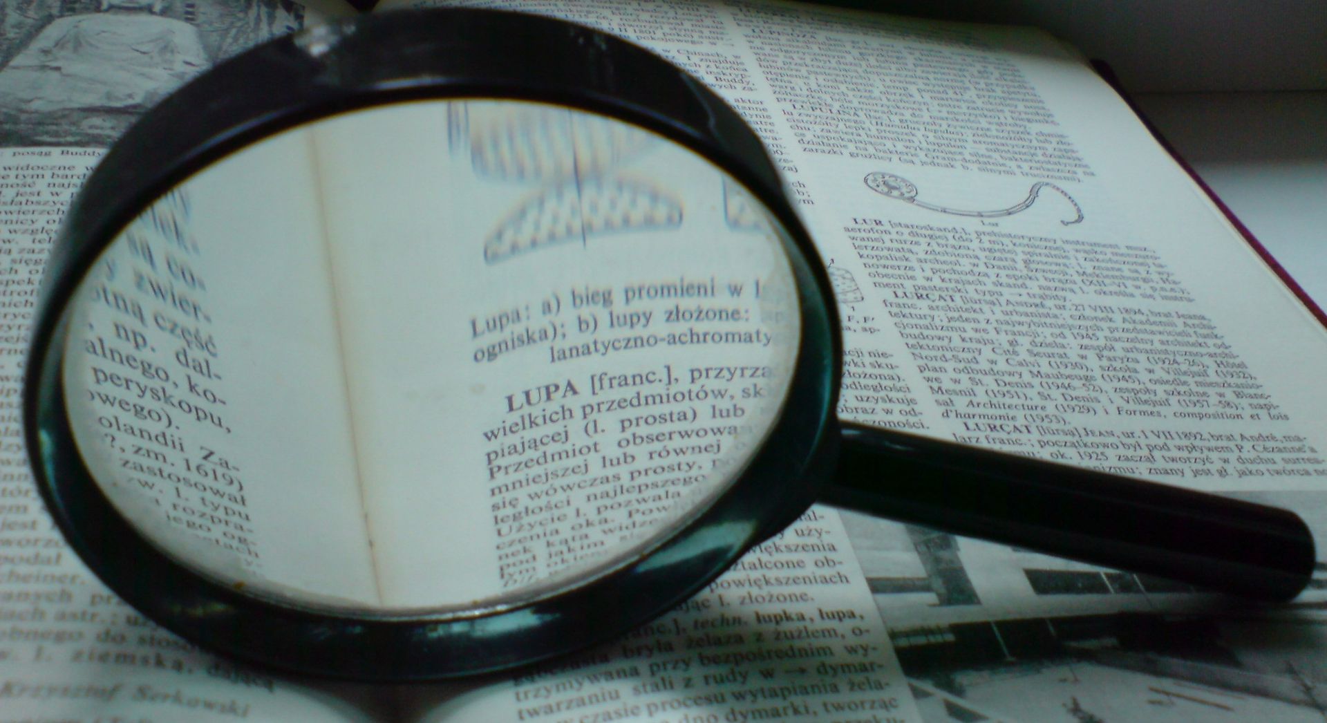 maginifying glass on dictionary